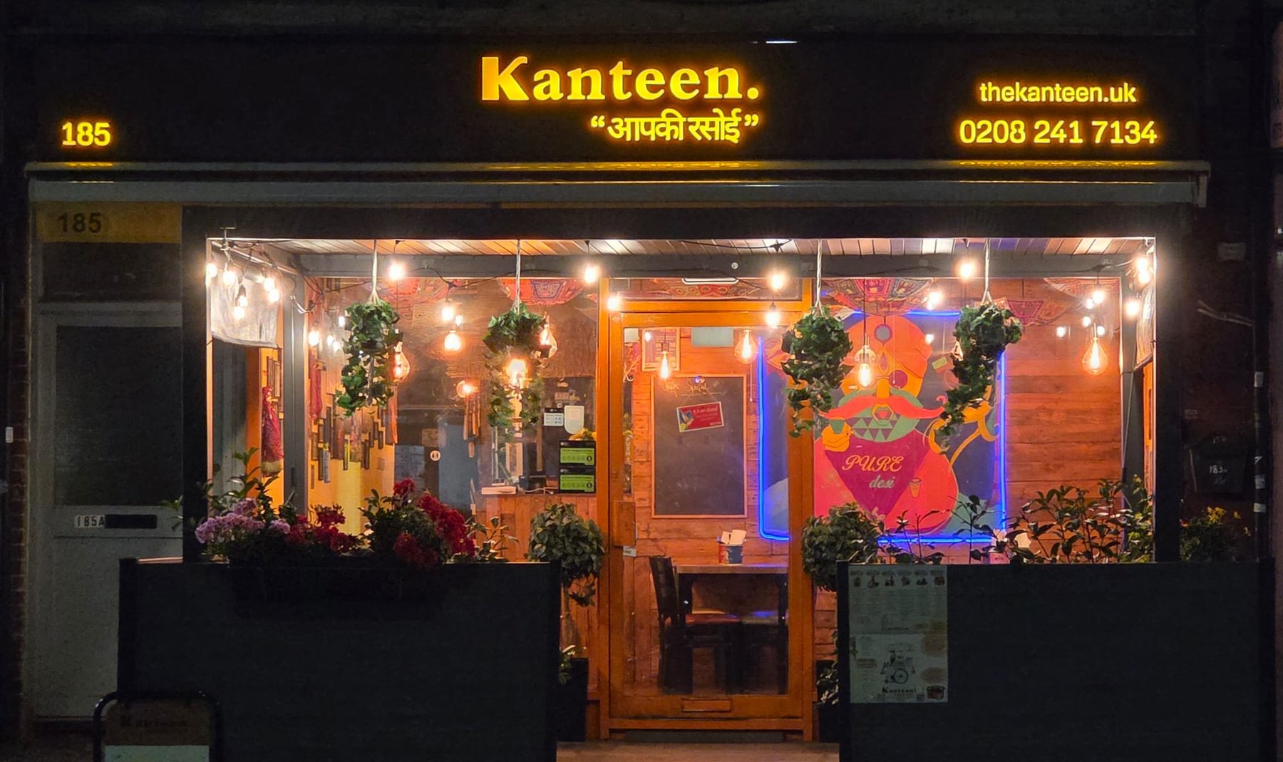 Kanteen's shopfront in Wallington, glowing at night
